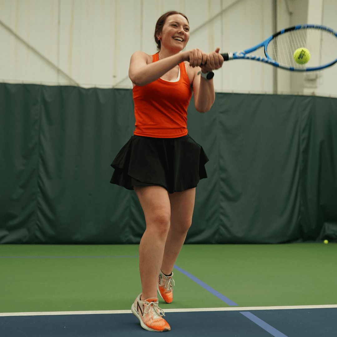 College student playing tennis at the Decatur Athletic Club